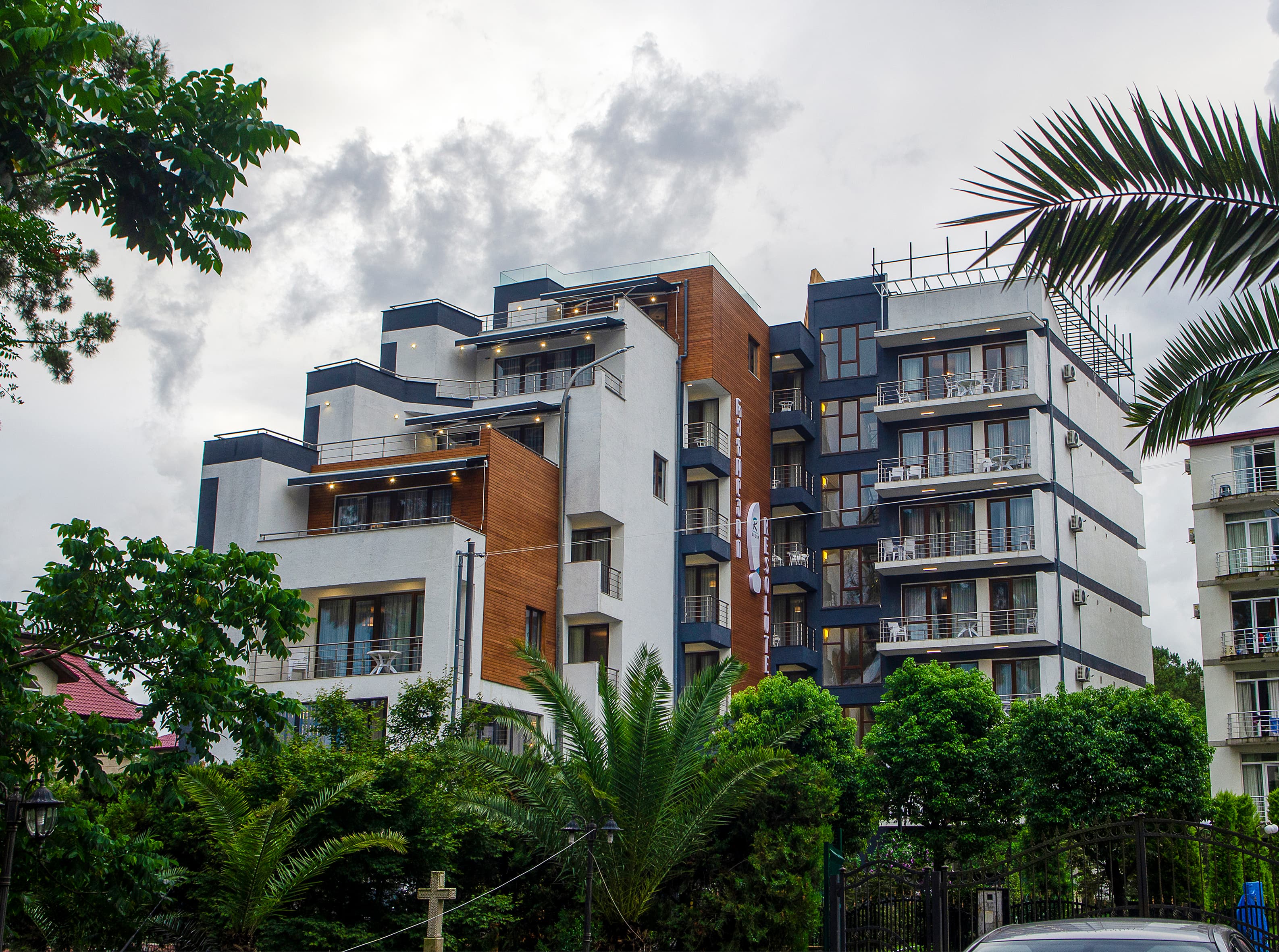 Resolute Hotel exterior, low-angle view with palm trees